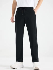 Men's ice silk straight sports pants with drawstring waist shown on model with sneakers