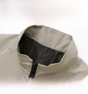 Close-up of the beige stand collar and zipper detailing on a casual men's jacket
