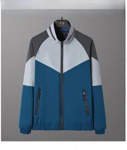 Detail view of the geometric color-block design and zipper pockets on the men's jacket