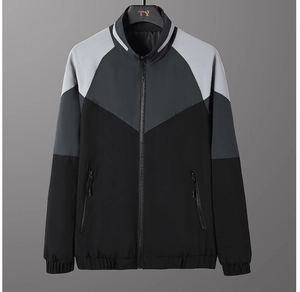 Detail of men's casual jacket with gray color-block design and stand-up collar