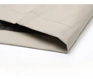 Detailed view of the khaki baseball jacket hem featuring high-quality stitching and fabric