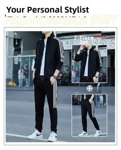 Close-up of black men's tracksuit with three beige stripes on jacket sleeves and pants