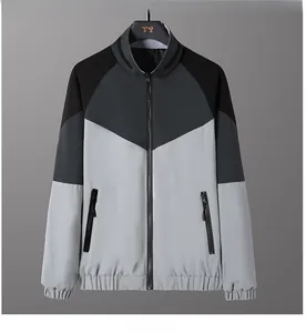 Detail of men's tricolor patchwork jacket featuring stand collar and zip pockets