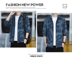 Detail view of men's hooded sun protection jacket with dark blue geometric camo pattern