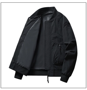 Detail of black bomber jacket featuring ribbed cuffs and metal zipper closure system