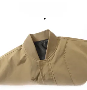 Close-up detail of khaki bomber jacket ribbed collar with clean stitching and grey lining