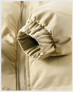 Detail view of khaki winter jacket featuring elastic windproof cuffs and resin zipper