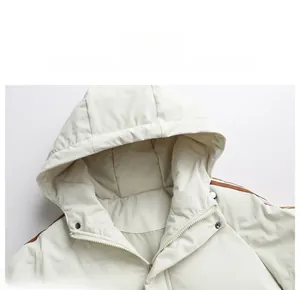 Close-up of windproof high-neck hood and shoulder stripes on a beige padded jacket