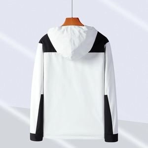 Waterproof outdoor jacket in black and white color block design, hooded back view display