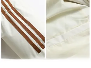 Detail of three-stripe sleeve design and inner hidden pocket on padded winter jacket