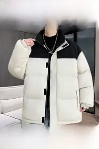 Detail of a thick two-tone padded jacket featuring a high collar and warm black and white panels