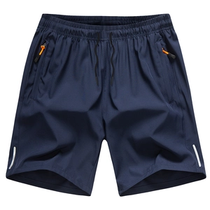 Navy sports shorts with zippered pockets, orange accents, and reflective safety strips