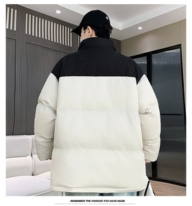 Rear view of the black and white two-tone puffer jacket showing the padded winter texture