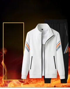 Detail of white stand-up collar jacket with orange sleeve stripes and black joggers
