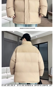 Detail view of khaki winter jacket with stand-up collar and horizontal stitching