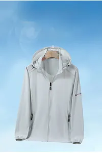 Detail of light gray sun protection jacket showing zip pockets and adjustable drawstring hood