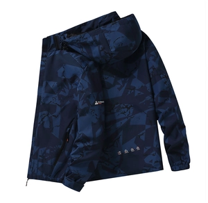 Detailed view of waterproof camouflage outdoor jacket with hood and brand logo on chest