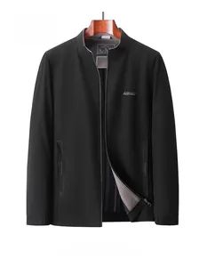 Detail of black stand collar jacket with zipper and textured fabric on wooden hanger