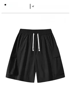 Detail view of black cargo shorts featuring elastic waist and white contrast drawstrings