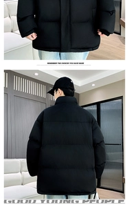Detail view of black padded puffer jacket showing ribbed cuffs and back silhouette