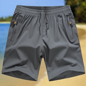 Grey quick-dry men's sports shorts with elastic drawstring waist and orange zipper pockets