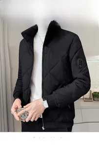 Detail of men's black quilted jacket with standing collar and arm shield badge