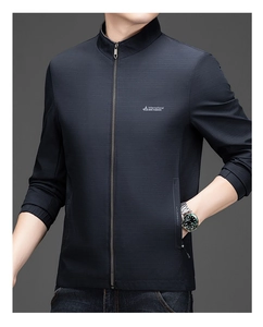Detail of dark blue men's jacket showing textured fabric, stand collar, and metal zipper