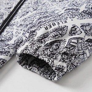 White windproof jacket featuring vintage map print with elastic cuffs and zipper detail