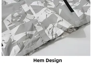 Detail of the camouflage outdoor jacket hem featuring precise stitching and waterproof fabric