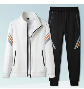 Flat lay of white stand-collar jacket and black joggers with orange side stripes