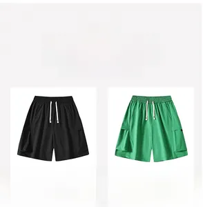 Flat lay of cargo shorts in black and mint green with drawstring waist and flap pockets