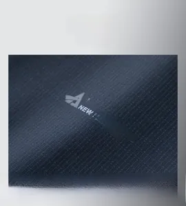 Detail of dark textured fabric with light blue A international logo on a men's casual jacket