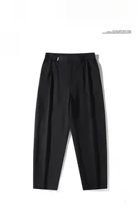 Close-up of black men's straight casual trousers with classic center crease detail