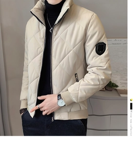 Detail of men's beige quilted stand collar jacket with ribbed cuffs and sleeve patch