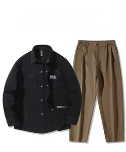 Close-up of khaki casual pants with elastic waistband and button detail in a set