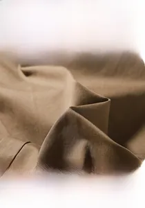 Detail of high-density brown fabric showing anti-pilling and tear-resistant texture