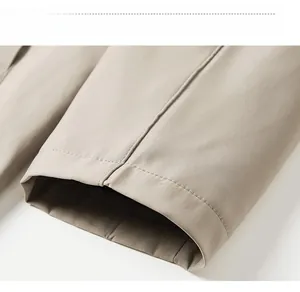 Detail of khaki men's business casual jacket sleeve with fine stitching and woven texture
