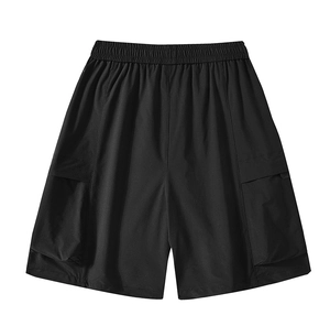 Detail of men's black cargo shorts featuring elastic drawstring waist and large flap pockets