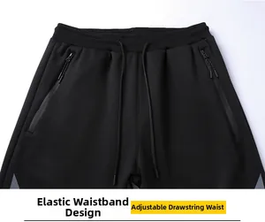 Detail of elastic waistband with adjustable drawstring and zip pockets on black joggers