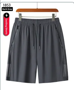 Detail of dark grey quick-dry shorts featuring zipper pockets and reflective safety stripes