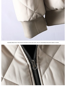 Detail of beige quilted jacket showing elastic ribbed cuffs and metal zipper quality