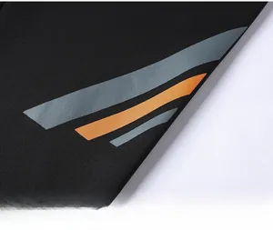 Close-up of black sportswear fabric featuring diagonal grey and orange stripes