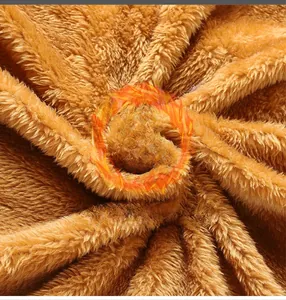 Close-up of thick brown fleece fabric texture showing high-density thermal insulation fibers