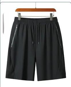 Detail view of black ice silk sports shorts with elastic drawstring waist and zip pockets
