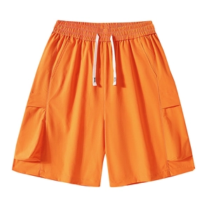 Detailed view of orange cargo shorts featuring elastic drawstring waist and side patch pockets
