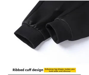 Detail of classic black ribbed ankle cuffs on men's athletic jogger pants