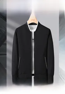 Detail view of a black bomber jacket collar and side pocket with white trim accents