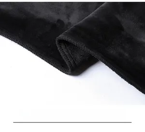 Close-up of black velvet sportswear fabric showing high-density stitching and overlock edge