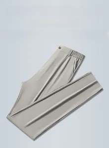 Detailed view of elastic waist and textured ice silk fabric on light grey men's trousers