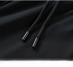 Close-up of the adjustable drawstring with metal tips on men's black ice silk shorts